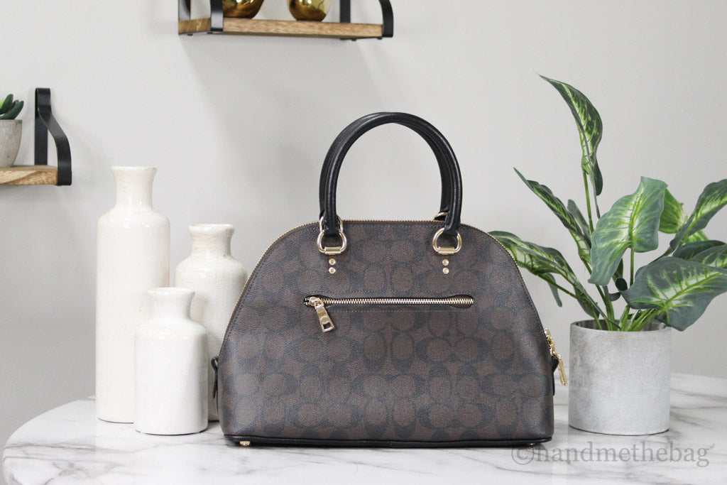 coach katy brown black dome satchel back on marble table