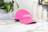 versace hot pink baseball cap on marble table