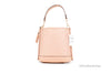 coach mollie 22 shell pink straw bucket back on white background