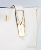 coach derby chalk tote detail on white background