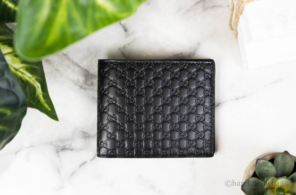 gucci microguccissima bifold wallet on marble table