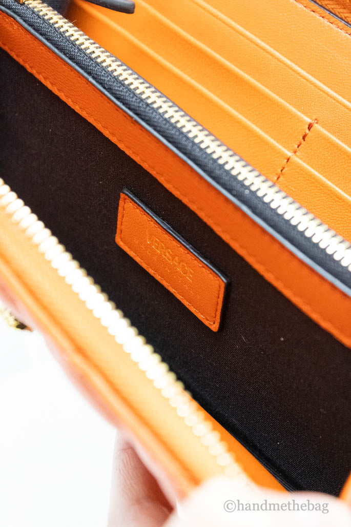 versace dark orange quilted clutch wallet inside on white background