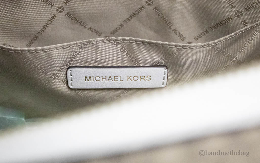 michael kors travel light cream patches duffle inside on white background