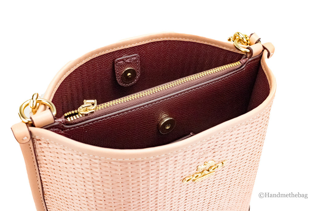 coach mollie 22 shell pink straw bucket inside on white background