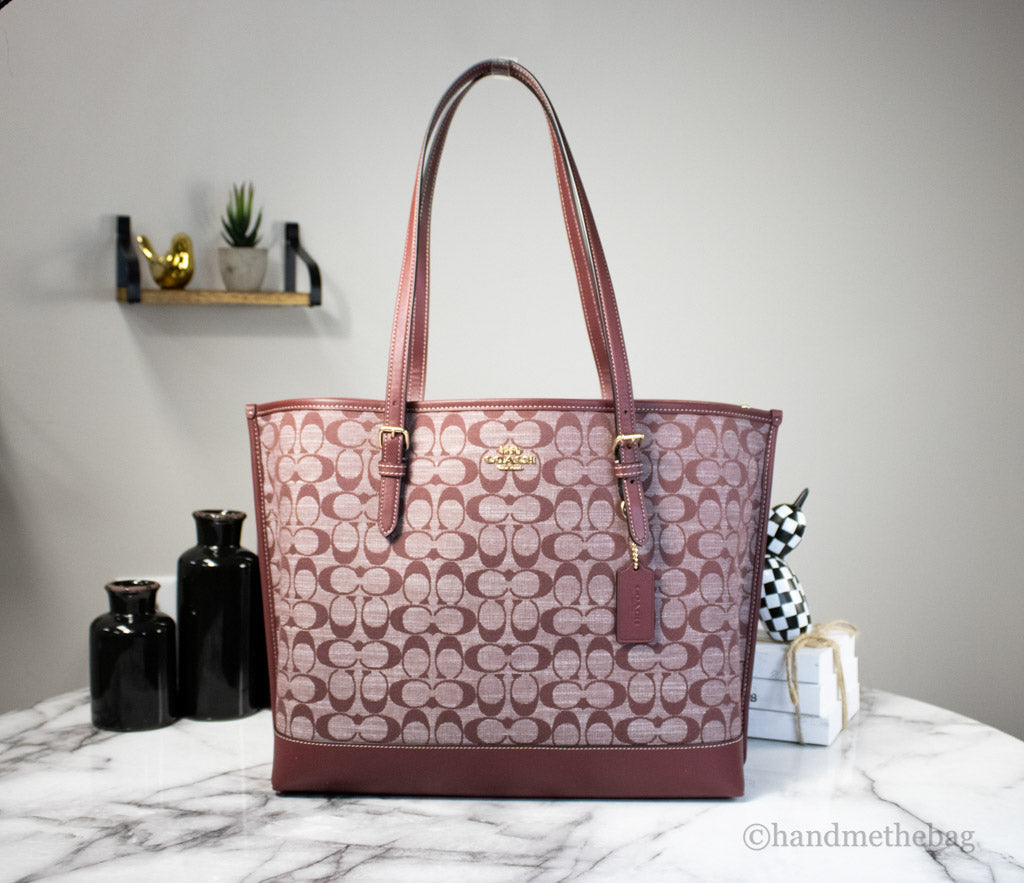 coach mollie wine canvas tote on marble table