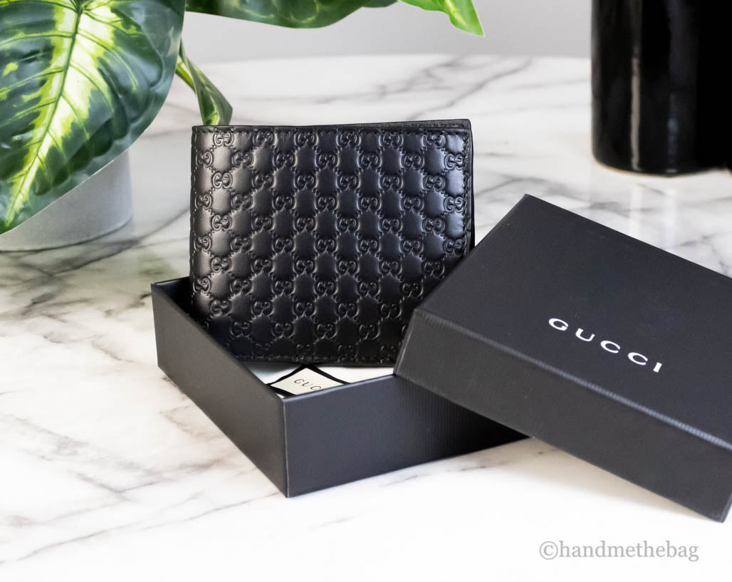 gucci microguccissima bifold wallet in box on marble table