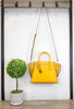 michael kors avril small honeycomb satchel on wooden stand