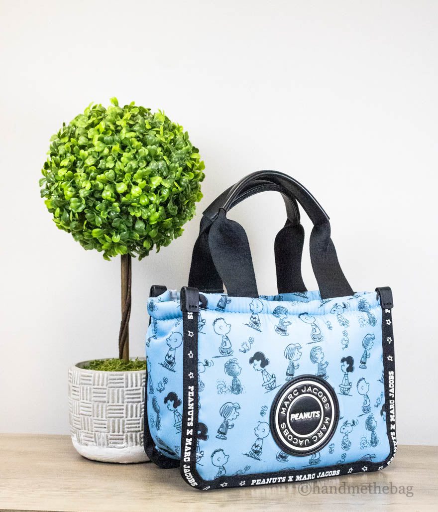 marc jacobs x peanuts air blue puffy tote on wood table