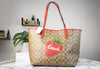 coach wild strawberry city tote on marble table