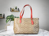 coach khaki electric red gallery tote on marble table
