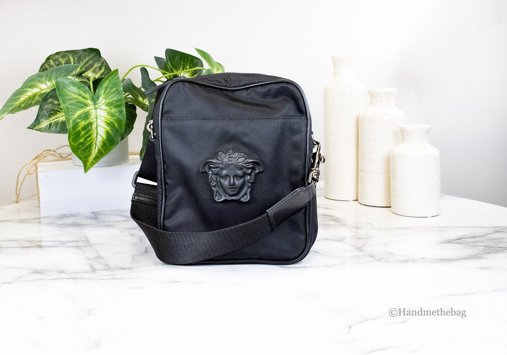 versace black nylon crossbody on marble table