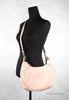 coach mara shell pink hobo shoulder bag on mannequin