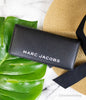 marc jacobs slim black wallet on marble table