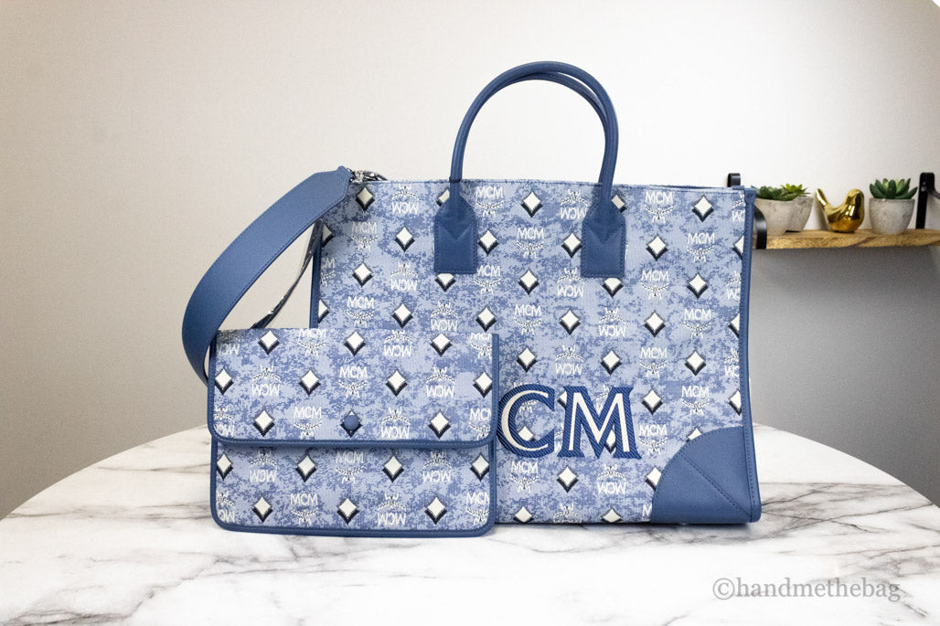 mcm munchen xl blue denim tote on marble table