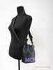 mcm mini black purple leather chain bucket bag on mannequin