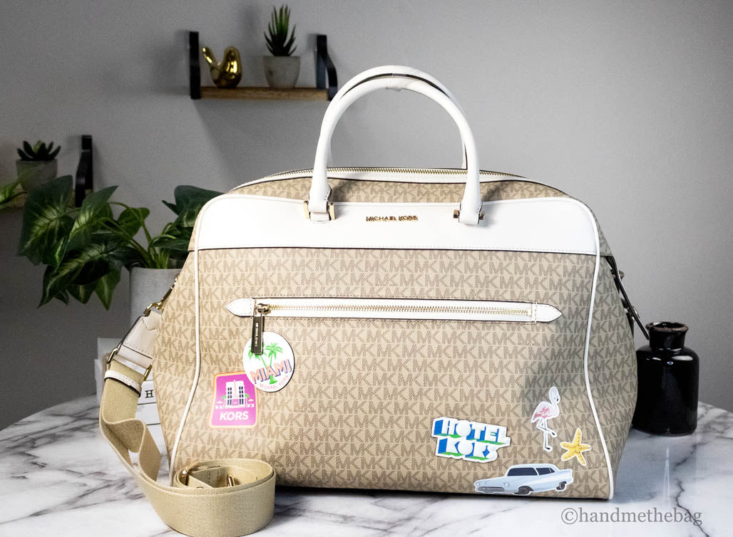 michael kors travel light cream patches duffle on marble table