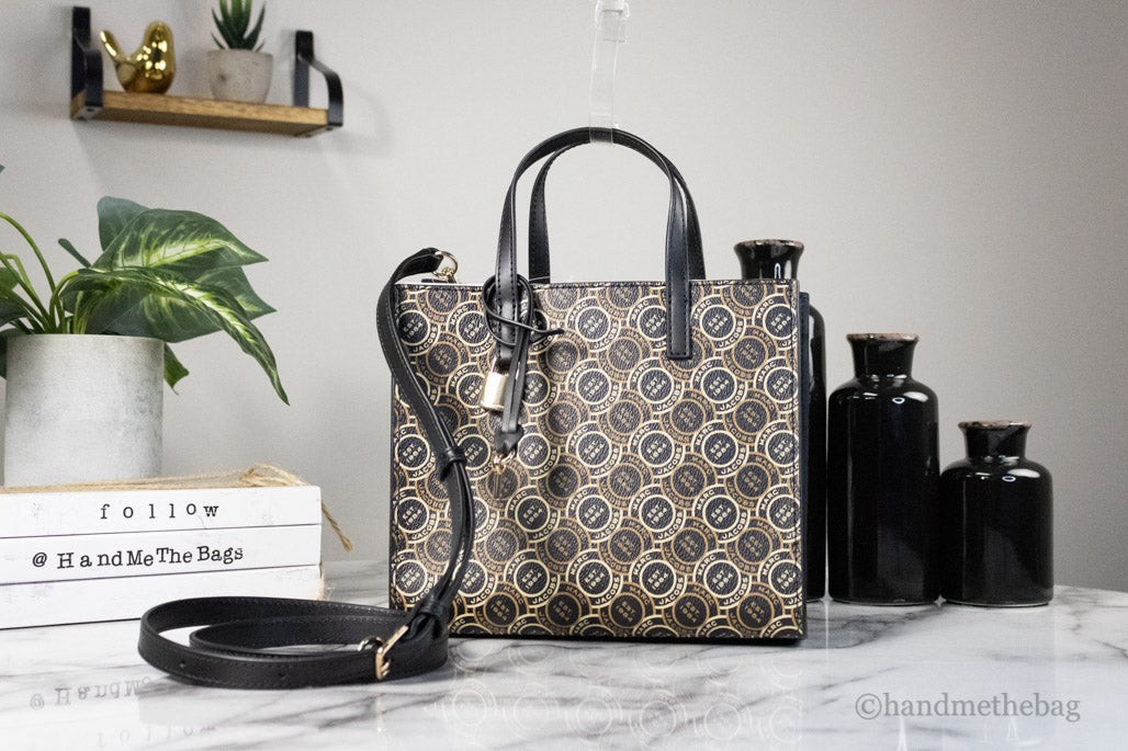 marc jacobs grind signet tote on marble table