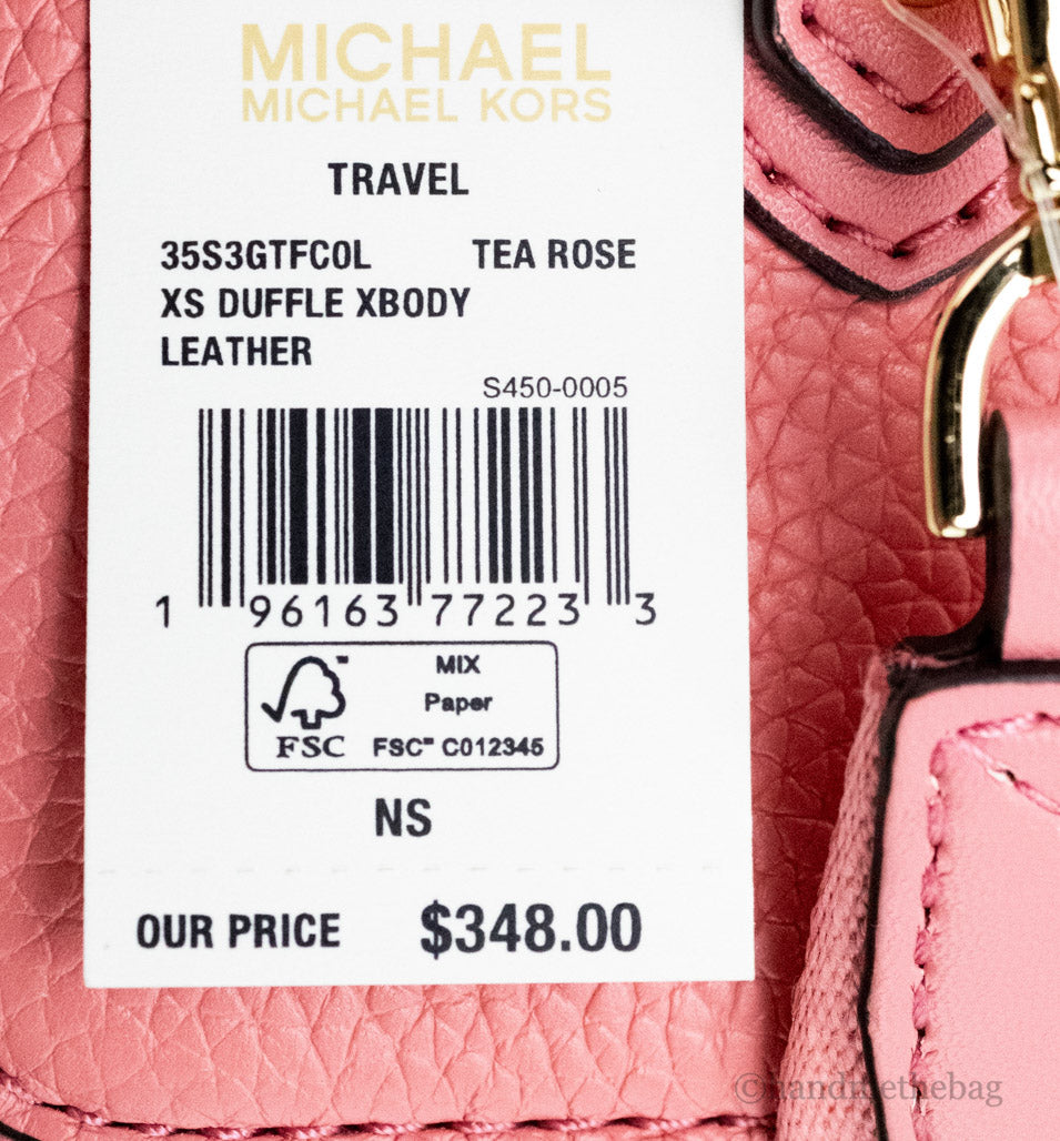 michael kors travel xs tea rose duffle crossbody tag on white background