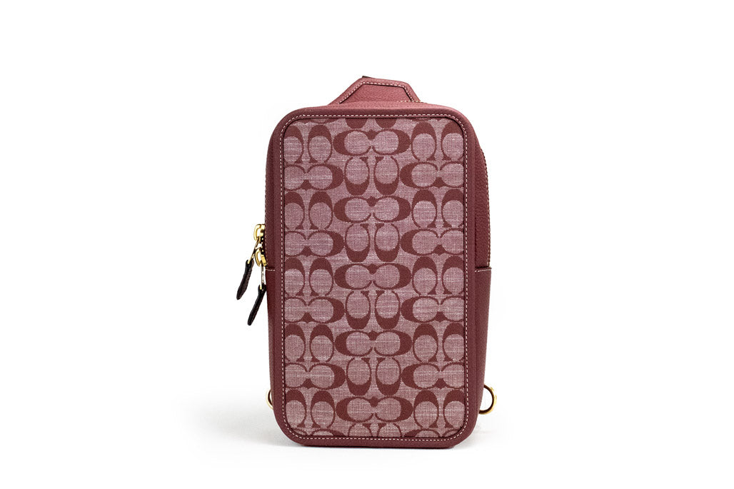 coach sullivan wine chambray pack on white background