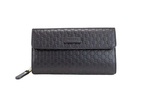 gucci microguccissima black clutch wallet on white background