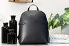Kate Spade staci black dome backpack on marble table