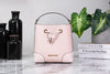 Michael Kors Mercer powder blush bucket crossbody on marble table