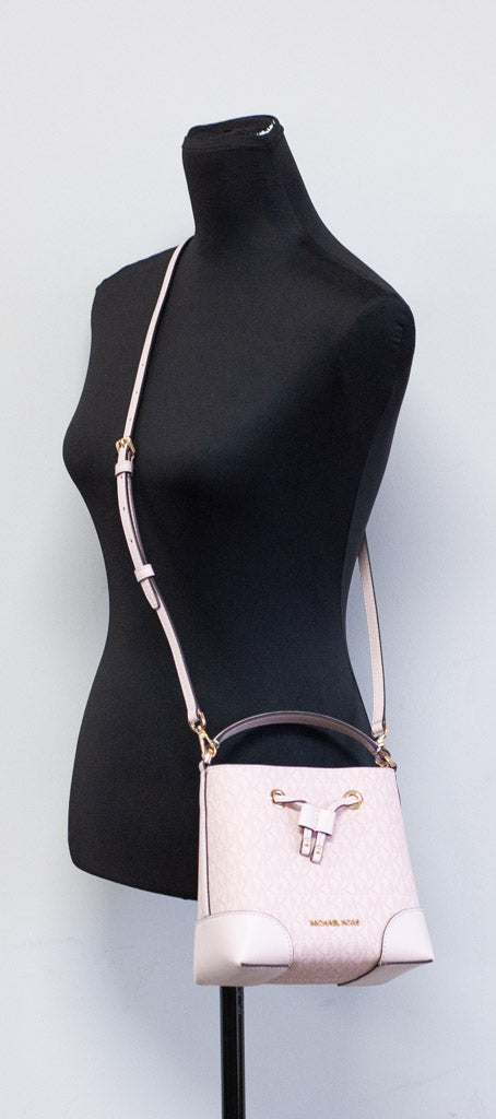 Michael Kors Mercer powder blush bucket crossbody on mannequin