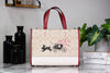 Coach Dempsey lunar new year tote on marble table
