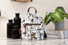 Dooney & Bourke Steamboat Willie backpack on marble table