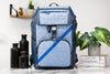 Michael Kors Cooper chambray flap backpack on marble table