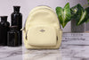 Coach Court pale lime mini backpack on marble table