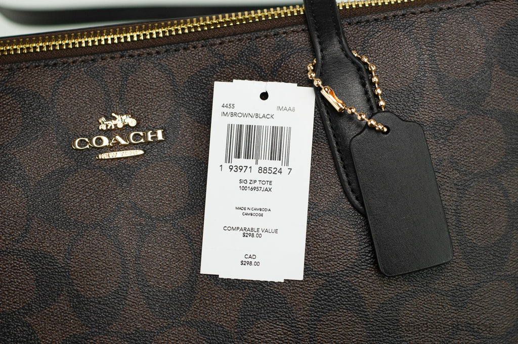 Coach brown black tote tag on white background