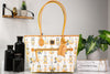 Dooney & Bourke Pinocchio tote on marble table