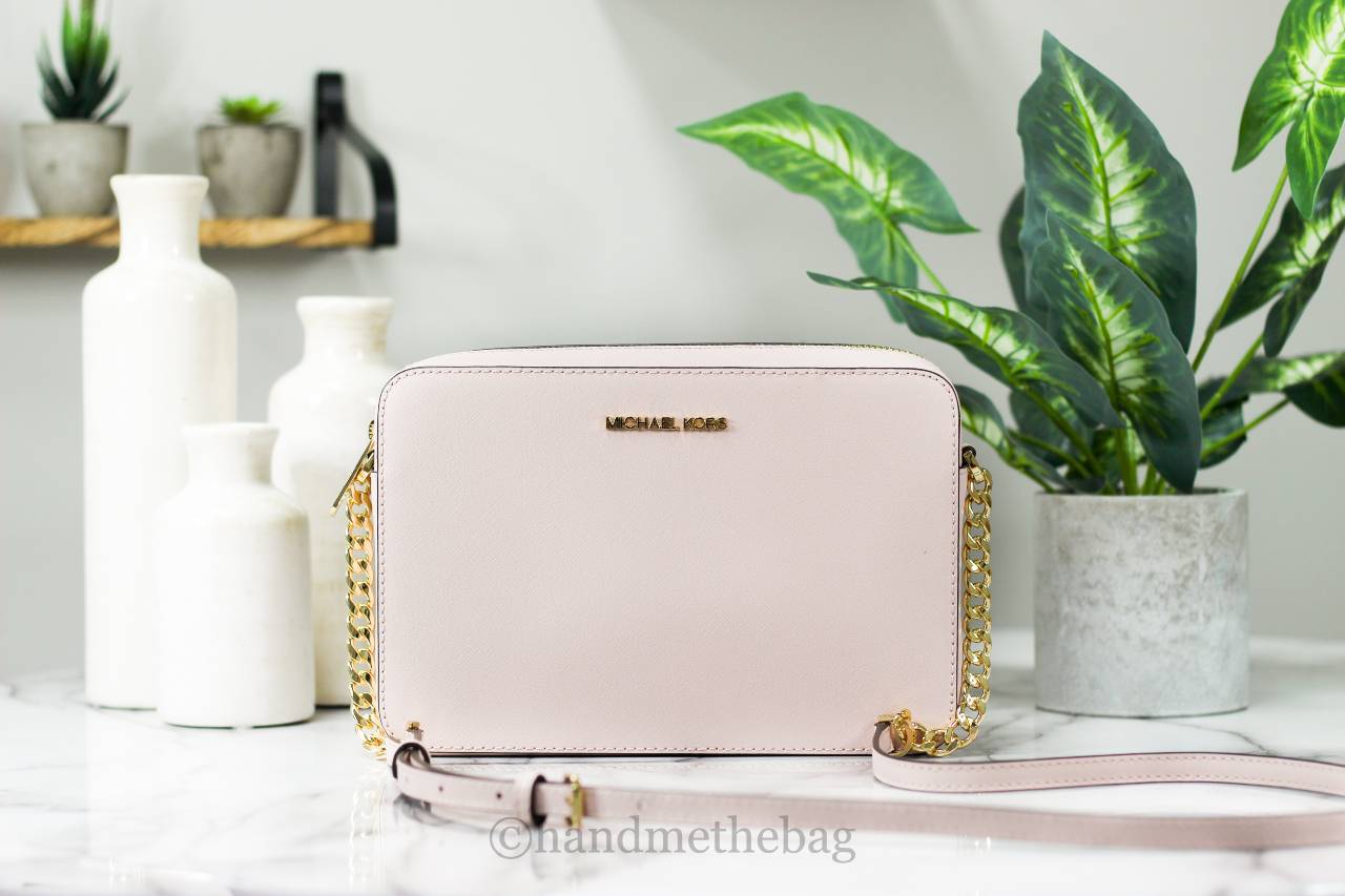 Michael Kors powder blush east west crossbody bag front on marble table