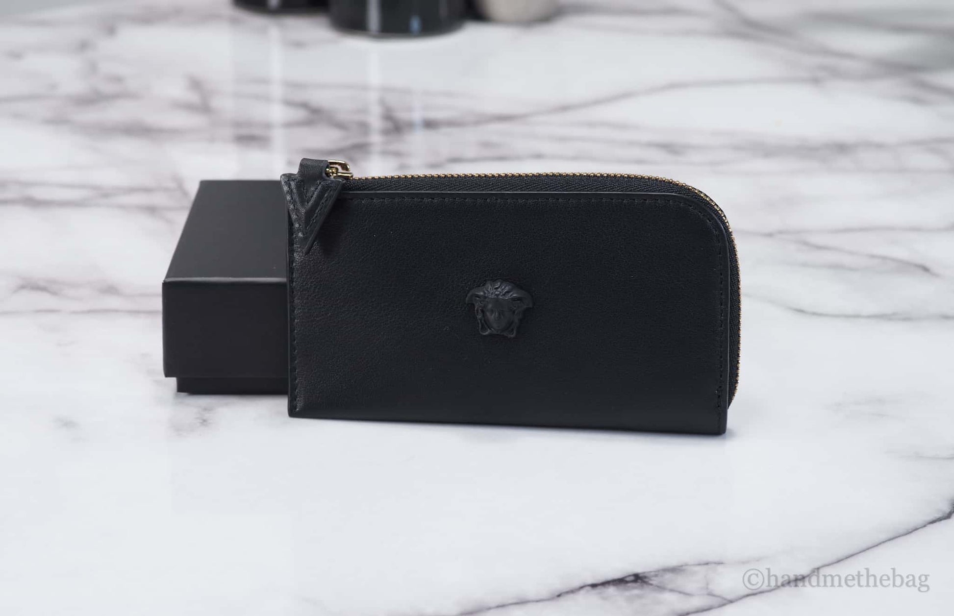 Versace black medusa card case on marble table