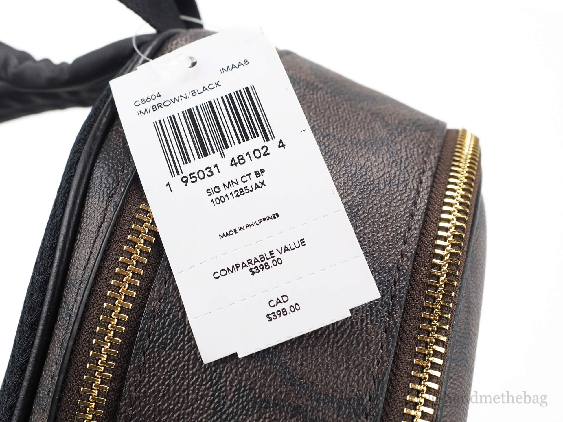 Coach brown black mini court backpack tag on white background