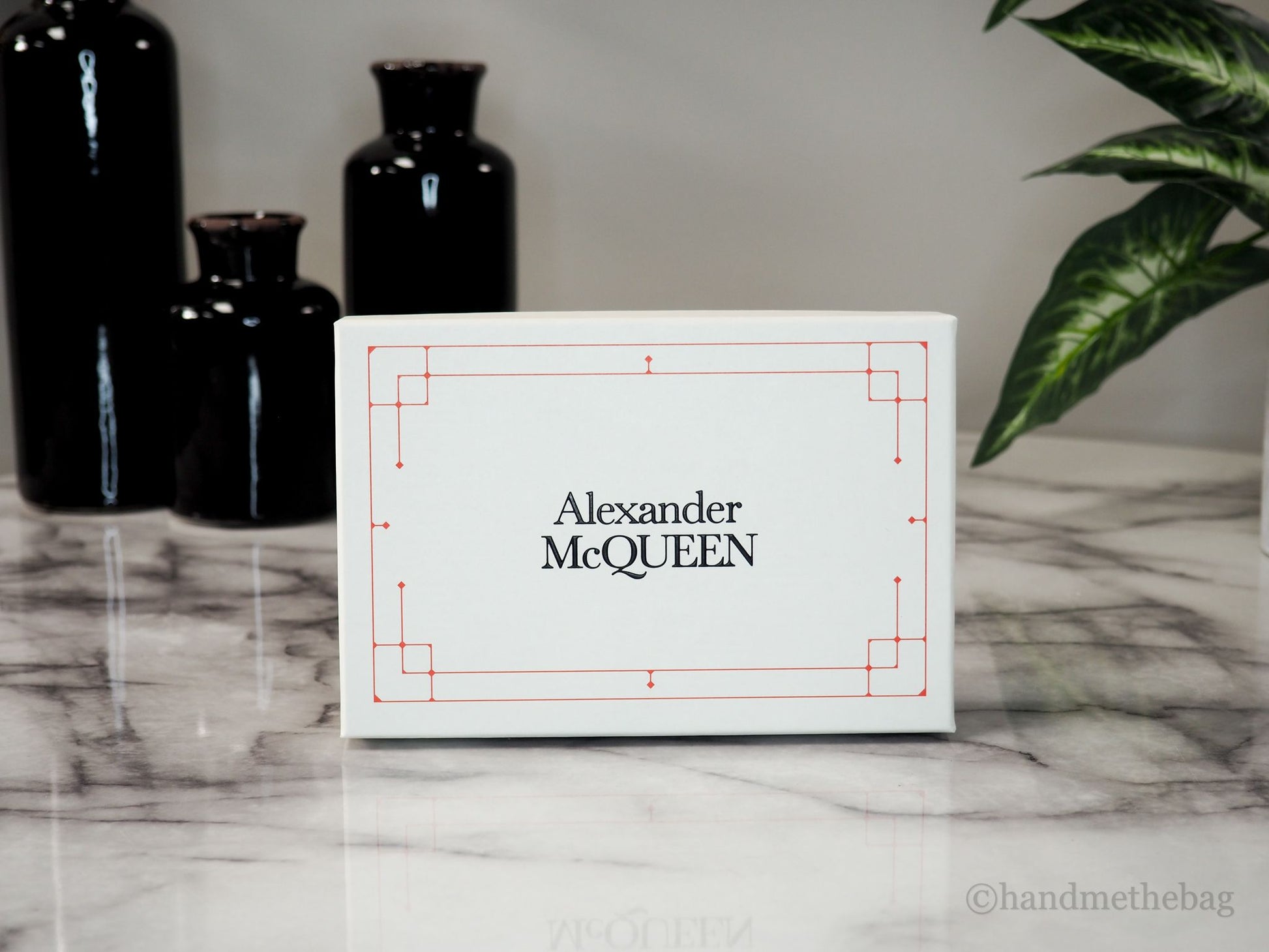 Alexander McQueen wallet box on marble table