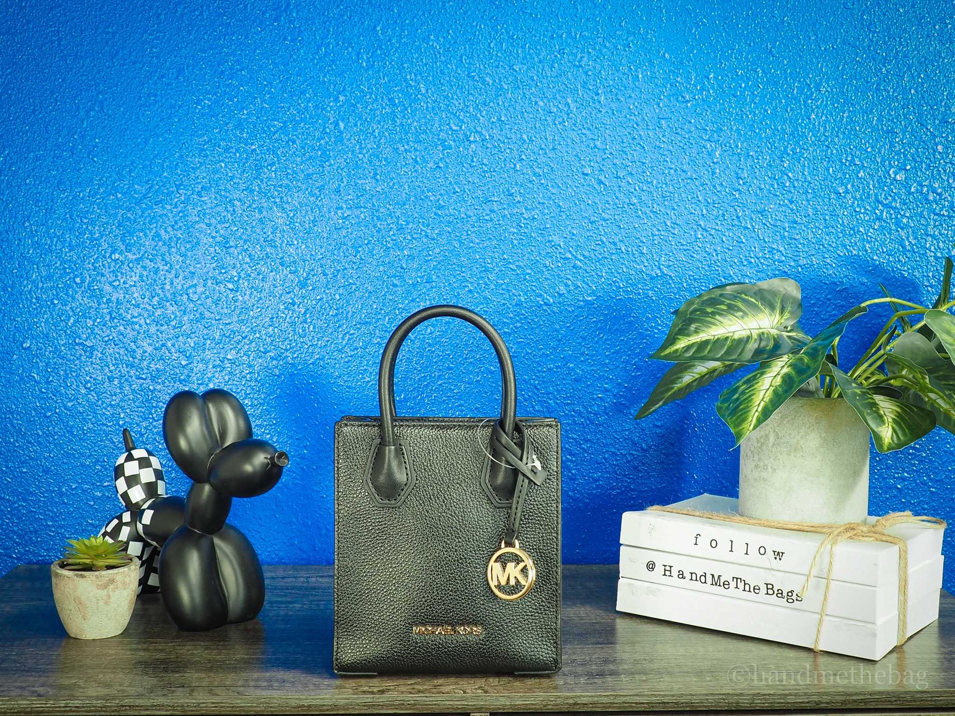 Michael Kors mercer black north south shopper bag against bright blue wall