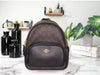 Coach brown black mini court backpack on marble table