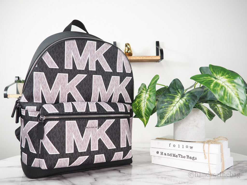 michael kors cooper black graphic logo backpack on marble table