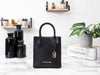 Michael Kors mercer black north south shopper bag on marble table