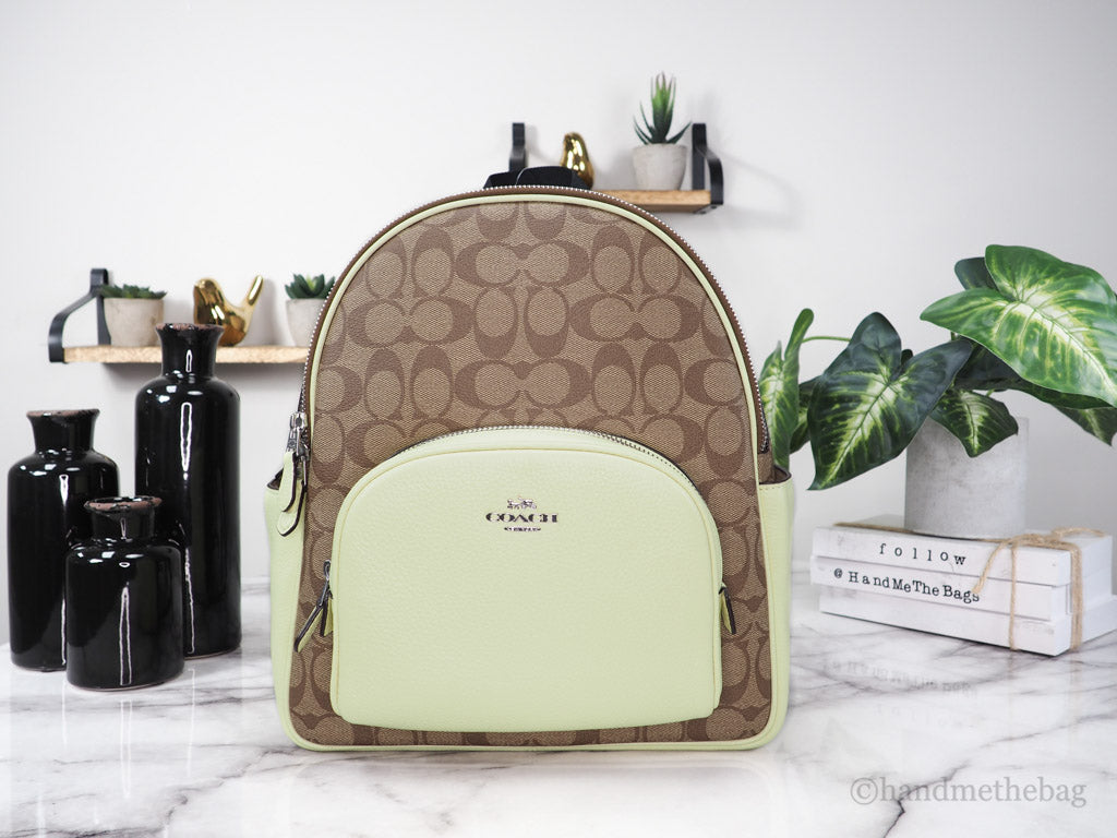 Coach Court khaki pale lime backpack on marble table