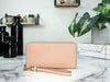 Coach faded blush long zip around wallet on marble table