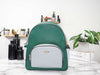 Coach Court green colorblock backpack on marble table