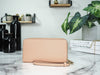 Coach faded blush long zip around wallet back on marble table
