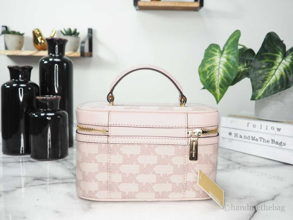 Michael Kors Jet Set powder blush trunk crossbody back on marble table