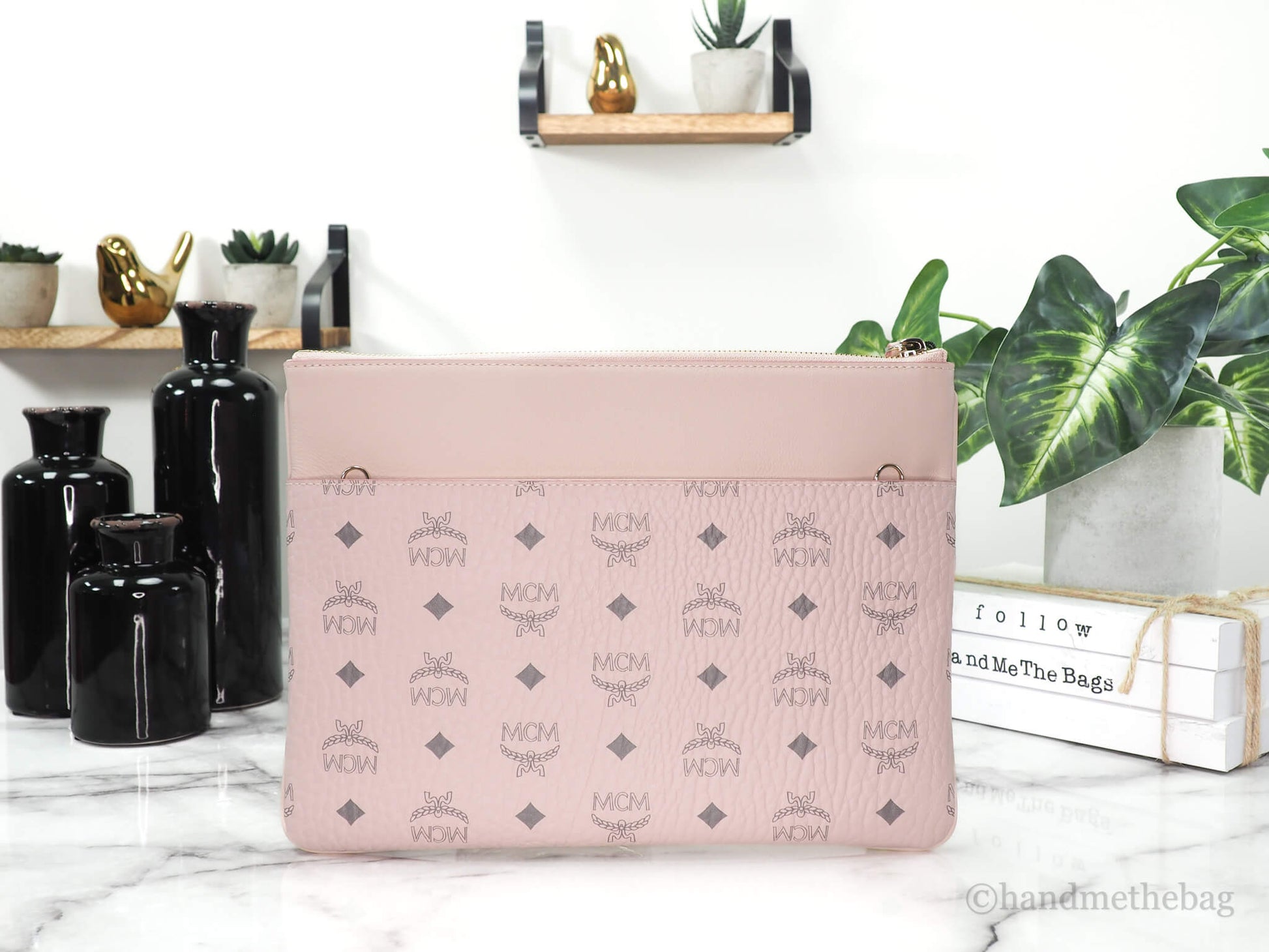 MCM portuna powder pink flat pouch on marble table