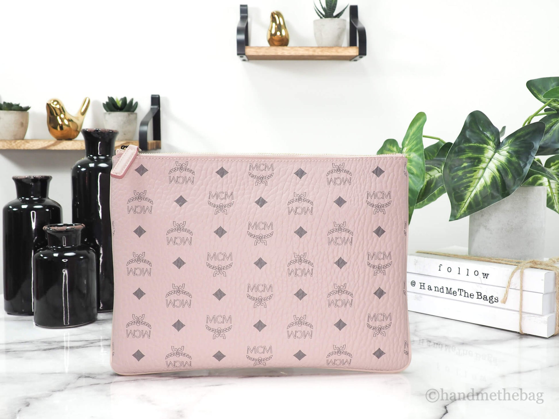 MCM portuna powder pink flat pouch back on marble table