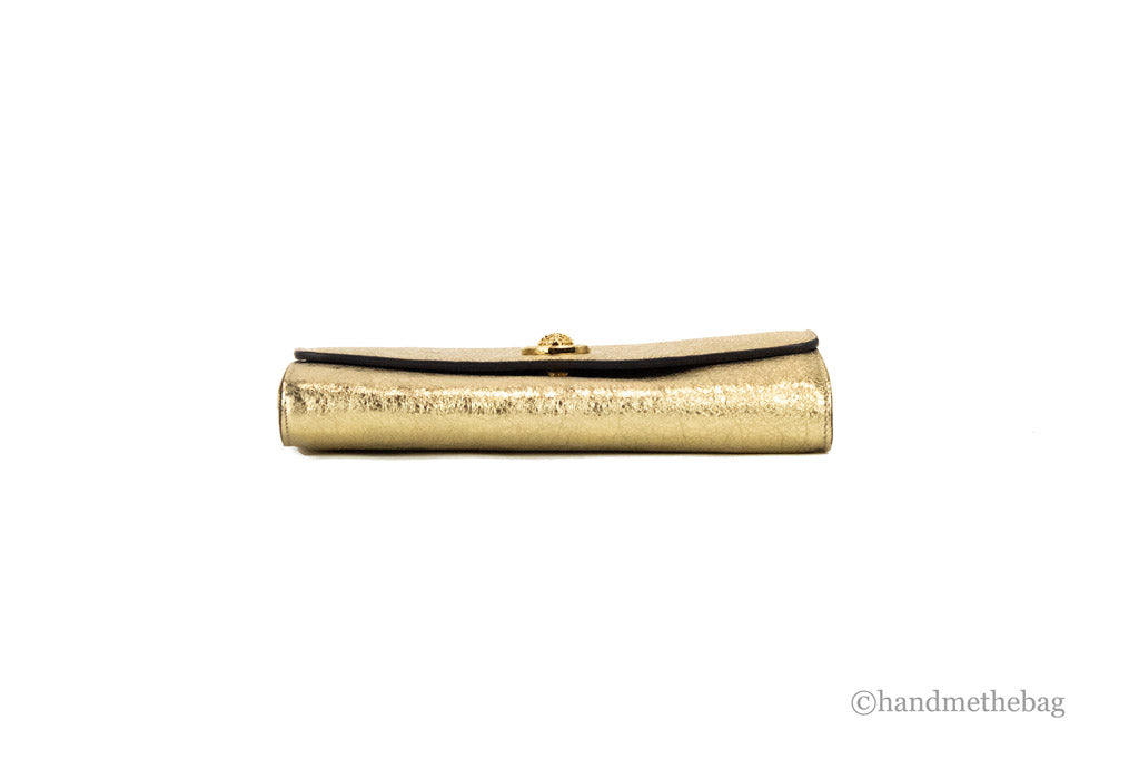 versace metallic gold evening bag bottom on white background