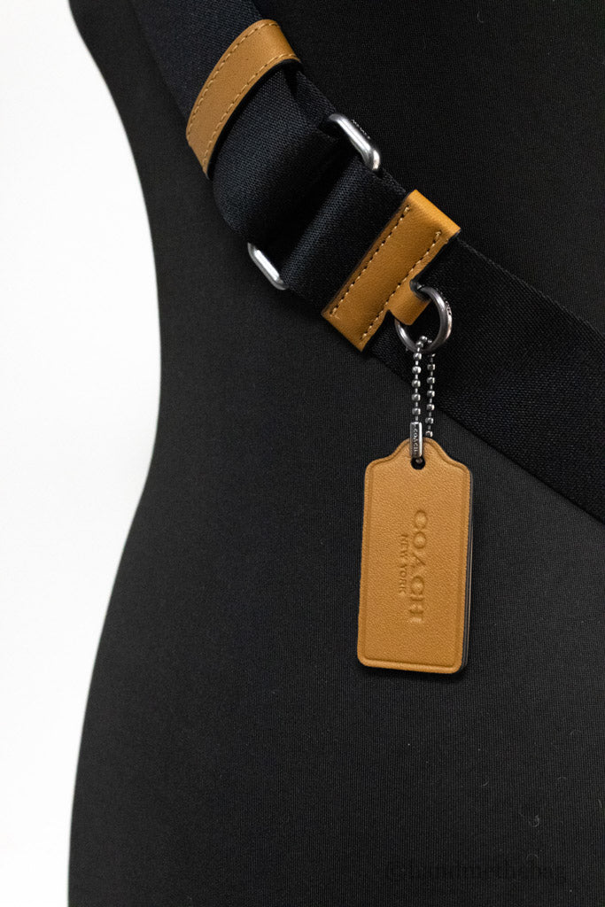 coach sullivan penny embossed pack detail on white background